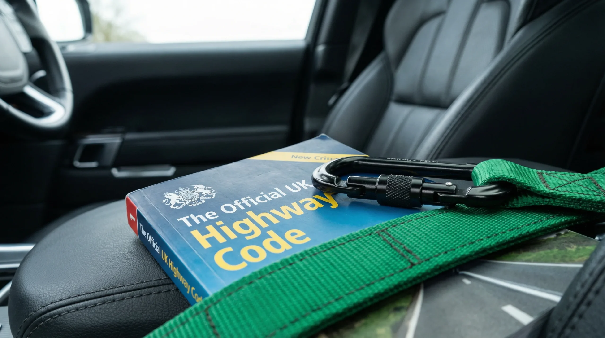 Dog car travel UK law reference showing the Highway Code Rule 57 and restraint requirements